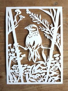 a cutout of a bird sitting on a tree branch