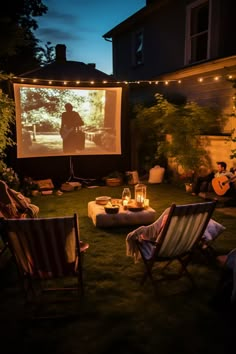 an outdoor movie is set up in the backyard