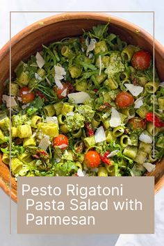 pasta salad with parmesan and tomatoes in a wooden bowl on a white table