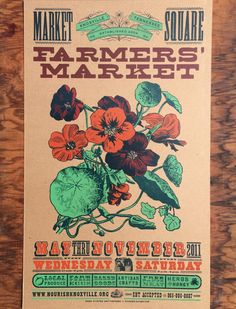 an old poster for farmers market with flowers on the front and back cover, sitting on a wooden table