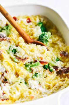 a casserole dish with broccoli, cheese and other vegetables in it