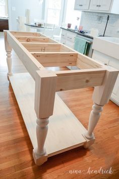 a kitchen island made out of wooden planks in the middle of a hardwood floor