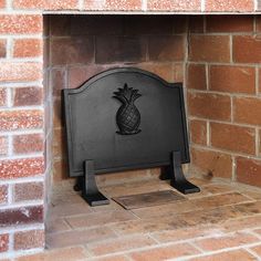 a brick fireplace with a pineapple design on it