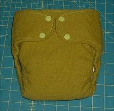 a cloth diaper sitting on top of a cutting board next to a blue mat