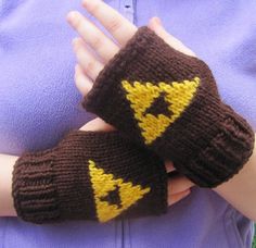 someone is holding their hands in knitted mittens with yellow lightning symbols on them