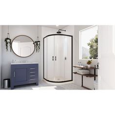 a bathroom with a sink, mirror and shower stall in the middle of the room