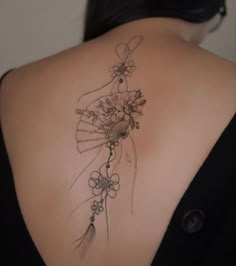 the back of a woman's shoulder with flowers on it