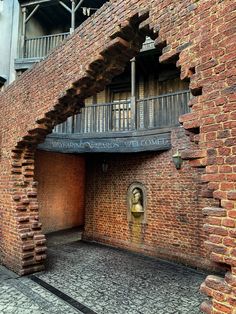 the entrance to an old brick building that has been converted into a tunnel for people to walk through