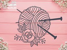 yarn and knitting needles with flowers on pink wood background for crochet svg file