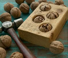 walnuts and a hammer on a wooden table