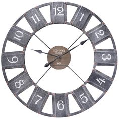 a large metal clock with numbers and numerals on the face, set against a white background