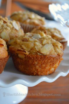 three muffins on a white plate sitting on a table