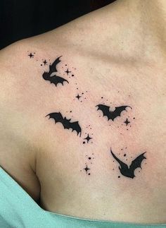 a woman's chest with bats and stars tattoo on her left side ribcage