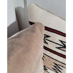 two pillows sitting next to each other near a door