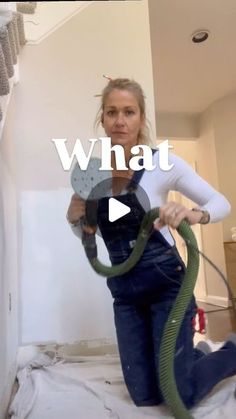 a woman in overalls with a hose on her back and the words, what?