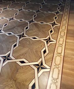 a wooden floor with an intricate design on the top and bottom part, inlayed to wood