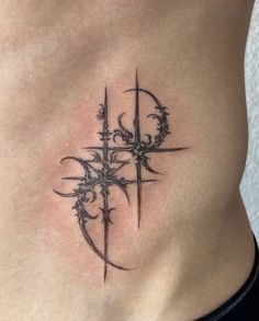 a tattoo on the side of a woman's stomach with an arrow and vines