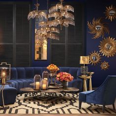 a living room with blue couches and chandeliers