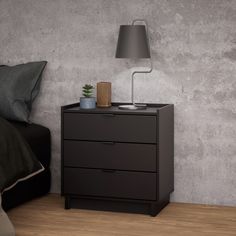 a night stand with two drawers and a lamp on it next to a bed in a room