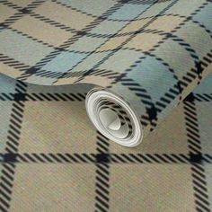 a close up view of a tie on a wallpapered floor with a checkered pattern