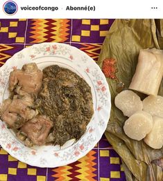 a plate full of food sitting on top of a purple and yellow table cloth next to other foods