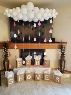 baby shower decorations with balloons hanging from the ceiling