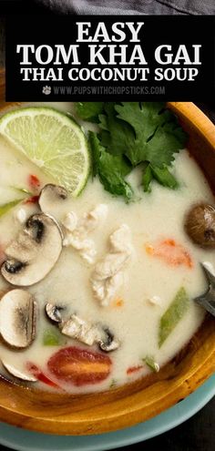 a bowl of thai coconut soup with mushrooms, lime and cilantro on the side