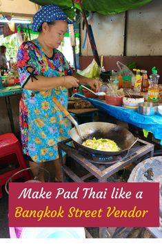 a woman cooking food on top of a wok