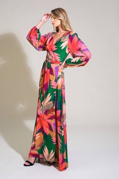 A printed woven maxi dress featuring surplice neckline, true wrap with tie and long sleeve Details: Self : 100% Polyester Lining : 100% Polyester Size & Fit - Model is 5`8" And Wearing Size Small- Measurements Taken From Size Small- Approx. Length: 60" Green V-neck Wrap Dress For Spring, Green V-neck Maxi Dress With Tie Waist, Green Surplice Neckline Maxi Dress For Spring, Vibrant Print V-neck Maxi Dress For Brunch, Green Surplice Neckline Dress For Fall, Elegant Green Floral Print Wrap Dress, Green Floral Print Long Sleeve Maxi Dress, Floral Print Maxi Wrap Dress For Party, Green Long Sleeve Maxi Dress With Floral Print