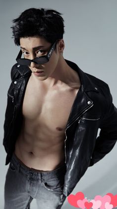 a shirtless man wearing a black leather jacket and eye patch on his face with hearts in the background