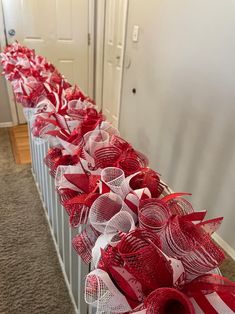 several red and white bows lined up on a radiator