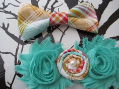 two hair bows on top of each other with different colors and designs in the background