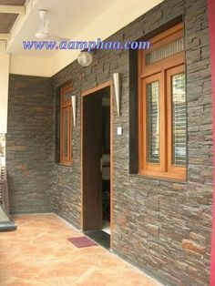 the entrance to a house with stone walls and doors