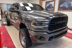 a gray ram truck parked in a showroom