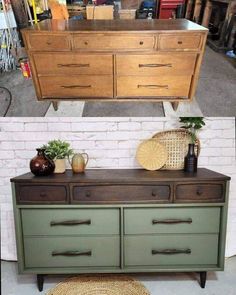 an old dresser has been painted green and is being used as a sideboard for storage