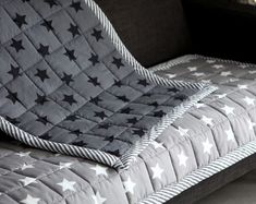 a gray couch with white stars on it