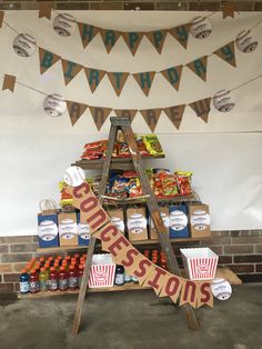 an outdoor birthday party with a sign that says happy birthday on it and lots of food