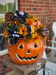 a decorated pumpkin sitting on top of a chair