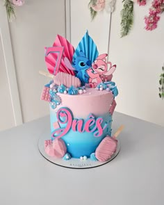 a birthday cake decorated with pink and blue frosting