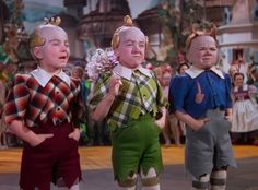 three children in costumes standing next to each other with their mouths open and hands clasped