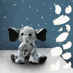 an elephant sitting on top of a table next to a blue and white wall with stars