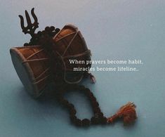 a wooden beaded drum sitting on top of a blue floor next to a string of beads