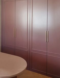 a white table and some purple cabinets in a room