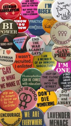 many different types of buttons with words written on them, all in different colors and sizes