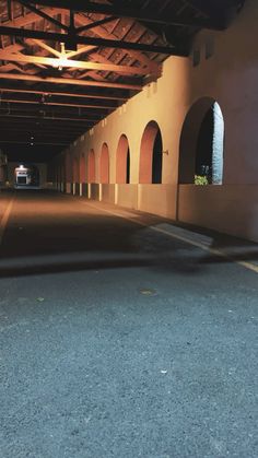 an empty parking garage with lights on and no one in the area to see it