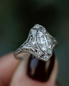 A close-up image showing an antique platinum art deco shield engagement ring with old european cut diamonds and filigree Copper Wedding Rings, 1920s Jewelry, Vintage Art Deco Rings, Shield Ring, Staghead Designs, Copper Wedding, Platinum Diamond Rings, Vintage Style Wedding, Antique Engagement Rings