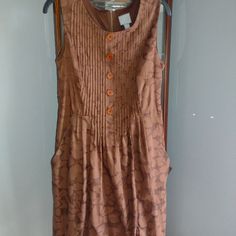 Brand Never Worn. Beautiful Design On Dress. Bodice Is Pleated. Buttons Down, Do Not Open. Zipper Down Back. Is Lined. Has Slash Pockets. Bust Is 17in Waist 16.5in Length 38in Very Flattering Dress. Brown Cotton Lined Dress, Brown A-line Daywear Dresses, Brown Sleeveless Pleated Dress, Brown A-line Dress With Buttons, Brown Sleeveless Dress With Buttons, Brown A-line Lined Dress, Casual Brown Cotton Dress, Brown Lined Knee-length Dress, Brown Knee-length Lined Dress