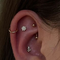 an ear with three different piercings on it