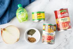 ingredients to make an apple cider recipe laid out on a white marble counter top