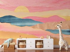 a giraffe standing in front of a wall mural